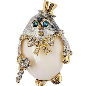 KENNETH JAY LANE, HUMPTY DUMPTY PIN WITH EMERALD EYES AND OFF WHITE BELLY